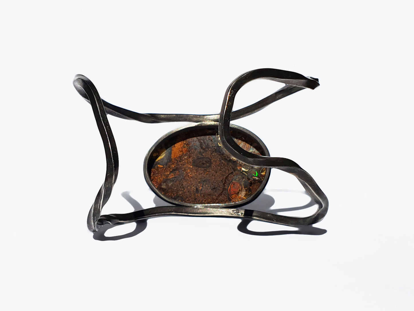Coroite Opal with bright opal flashes. All the colours of the rainbow show through warm earthy tones and set in an blacked silver cuff. Our products are all made with ethically sourced materials and handcrafted in our Brisbane based studio. Australian designed and made for high quality fine fashion.