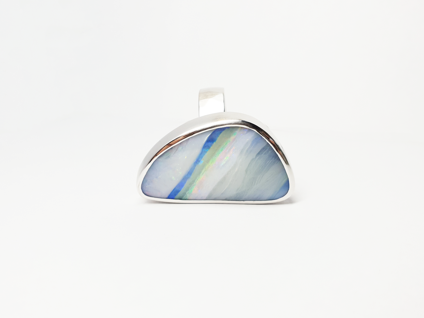 Solid Silver Queensland Boulder Opal ring. Australian made and handcrafted in our brisbane studio, this bright ring has streaks of blues and pinks throughout, resembling a rainbow.