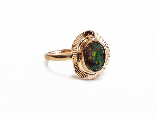 Green, Blue and Red Queensland Boulder Opal set in 9ct Rose Gold ring. Rose gold fans out around the stunning opal creating a unique and high quality ring. Australian made, and hand crafted for a unique style. Our products are all made with ethically sourced materials and handcrafted in our Brisbane studio