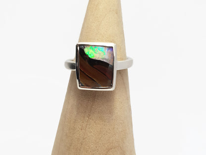 Square Queensland boulder opal set in silver. You can see the stone through the opal. Locally sourced and ethically sourced materials. Handcrafted, Australian designed, Australian made for a high fashion product